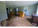 Spacious living room with hardwood floors, ample natural light, and vintage furniture at 647 Mckay Hill Rd, Mount Gilead, NC 27306