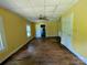 Spacious living room featuring hardwood floors, ceiling fan, and multiple entryways at 647 Mckay Hill Rd, Mount Gilead, NC 27306