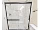Bathroom featuring a glass enclosed shower with white tile and black hardware at 6756 Denver Heights Cir, Denver, NC 28037