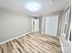 Neutral bedroom with wood-look floors and closet at 6756 Denver Heights Cir, Denver, NC 28037