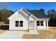 Charming new construction features white siding and a welcoming front porch with a concrete driveway at 6756 Denver Heights Cir, Denver, NC 28037
