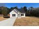 Charming new construction features white siding and a welcoming front porch and a concrete driveway at 6756 Denver Heights Cir, Denver, NC 28037