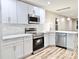 Modern kitchen with white cabinets, stainless steel appliances, marble backsplash and eat-in island at 6756 Denver Heights Cir, Denver, NC 28037