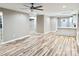 Open-concept living room features modern floors, neutral walls, and stylish ceiling fan at 6756 Denver Heights Cir, Denver, NC 28037