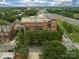 Aerial view showing the building and its location near a highway, trees, and other neighborhood buildings at 715 N Church St, Charlotte, NC 28202