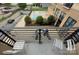 Balcony overlooking the community pool, lush greenery, and parking area, enhancing outdoor living enjoyment at 715 N Church St, Charlotte, NC 28202