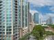 Stunning high-rise towers in a bustling city center, complemented by lush green trees and a quiet tree-lined street at 715 N Church St, Charlotte, NC 28202