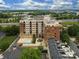 An aerial view of a brick apartment building that features a pool and lounging area at 715 N Church St, Charlotte, NC 28202