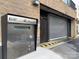 Exterior keypad for the building garage entrance with yellow safety markers at 715 N Church St, Charlotte, NC 28202