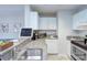 Well-lit kitchen with granite countertops, white cabinetry, and modern appliances at 715 N Church St, Charlotte, NC 28202