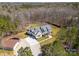 Expansive aerial view of a modern farmhouse-style home with a large yard, surrounded by dense trees at 722 Clegg Farm Dr, York, SC 29745