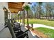 Inviting covered back porch with rocking chairs overlooking a lush, expansive yard at 722 Clegg Farm Dr, York, SC 29745