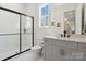 Stylish bathroom featuring gray vanity, glass-enclosed shower, and white tile flooring at 722 Clegg Farm Dr, York, SC 29745