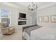 Comfortable bedroom featuring a fireplace and a sitting area near a large window at 722 Clegg Farm Dr, York, SC 29745