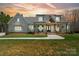 Beautiful white farmhouse exterior with a welcoming front porch and well-manicured lawn at 722 Clegg Farm Dr, York, SC 29745