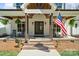 Charming front porch with brick steps, rocking chairs, and a view of the American flag at 722 Clegg Farm Dr, York, SC 29745