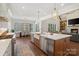 Open-concept kitchen with island seating, modern appliances, and a view of the dining and living areas at 722 Clegg Farm Dr, York, SC 29745