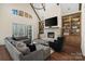 Bright living room with a stone fireplace, built-in bookshelves, and a comfortable gray sectional sofa at 722 Clegg Farm Dr, York, SC 29745