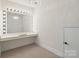 A bright room with vanity and Hollywood style lighting, providing an ideal space for dressing at 722 Clegg Farm Dr, York, SC 29745