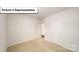 Simple bedroom with neutral carpet and two doors at 7729 Woolsey Dr, Gastonia, NC 28056