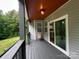 Back porch with outdoor seating and sliding glass doors to the kitchen at 8701 W Dixie Dr, Charlotte, NC 28278