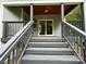 Stairs leading up to back porch with sliding glass door and gray siding at 8701 W Dixie Dr, Charlotte, NC 28278