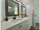 Elegant bathroom with double sinks, granite counters, and sleek black faucets at 8701 W Dixie Dr, Charlotte, NC 28278
