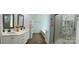 Bright bathroom features dual sinks, soaking tub and glass enclosed shower at 8701 W Dixie Dr, Charlotte, NC 28278