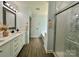 Modern bathroom featuring double vanities, and a glass enclosed walk-in shower at 8701 W Dixie Dr, Charlotte, NC 28278