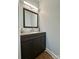 Stylish half-bathroom with a gray vanity, gray countertop, and a modern rectangular mirror at 8701 W Dixie Dr, Charlotte, NC 28278