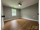 Bedroom with modern ceiling fan and hardwood floors at 8701 W Dixie Dr, Charlotte, NC 28278