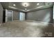 Spacious bedroom with soft carpeting, recessed lighting, and an open closet at 8701 W Dixie Dr, Charlotte, NC 28278