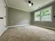 Bedroom with large windows and neutral carpet at 8701 W Dixie Dr, Charlotte, NC 28278