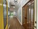Charming entryway featuring wood-look flooring and stylish wooden double doors to an office at 8701 W Dixie Dr, Charlotte, NC 28278