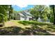 Aerial view showing the house, treed lot, and back porch at 8701 W Dixie Dr, Charlotte, NC 28278