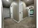 Beige hallway featuring white doors, trim, and plush carpeting at 8701 W Dixie Dr, Charlotte, NC 28278