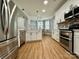 Well-lit kitchen features stainless steel appliances, modern white cabinets, and a center island at 8701 W Dixie Dr, Charlotte, NC 28278