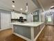Bright kitchen boasts a large island with quartz countertops and modern pendant lighting at 8701 W Dixie Dr, Charlotte, NC 28278