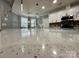 A close-up of the spacious kitchen island with shiny quartz countertops at 8701 W Dixie Dr, Charlotte, NC 28278