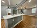 Open concept living room flows to a kitchen with stainless steel appliances at 8701 W Dixie Dr, Charlotte, NC 28278