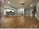 Open-concept living area with hardwood floors, recessed lighting, and easy access to the kitchen and staircase at 8701 W Dixie Dr, Charlotte, NC 28278