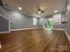 Spacious living room with a modern ceiling fan, new vinyl flooring, and natural light at 8701 W Dixie Dr, Charlotte, NC 28278
