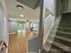 Inviting living area with hardwood floors, leading to a dining area and a staircase at 8701 W Dixie Dr, Charlotte, NC 28278
