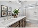 Bathroom with double vanity, decorative mirrors, and bathtub with shower in a modern setting at Lot 003 Bozeman Ct # 3, Stanley, NC 28164
