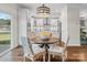Cozy breakfast nook with large windows, hardwood floors, and a view of the modern kitchen, perfect for casual dining at Lot 003 Bozeman Ct # 3, Stanley, NC 28164