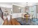 Open-concept dining room with elegant wainscoting, a stylish chandelier, and hardwood floors, perfect for Gathering meals at Lot 003 Bozeman Ct # 3, Stanley, NC 28164