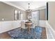 Formal dining room featuring classic wainscoting, an elegant chandelier, and a stylish rug, perfect for hosting gatherings at Lot 003 Bozeman Ct # 3, Stanley, NC 28164