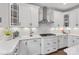 Modern kitchen featuring white cabinets, quartz countertops, and stainless steel range hood at Lot 003 Bozeman Ct # 3, Stanley, NC 28164