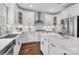 Modern kitchen featuring white cabinetry, stainless steel appliances, a center island, and sleek finishes, combining style with functionality at Lot 003 Bozeman Ct # 3, Stanley, NC 28164