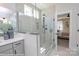 Bright bathroom featuring glass shower with bronze hardware and tile surround at Lot 29 Bozeman Ct # 29, Stanley, NC 28164